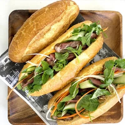 Vietnamese bánh mì sandwiches with grilled meat and fresh herbs