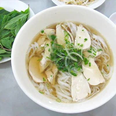 Kids-size bowl of pho with chicken and vegetables